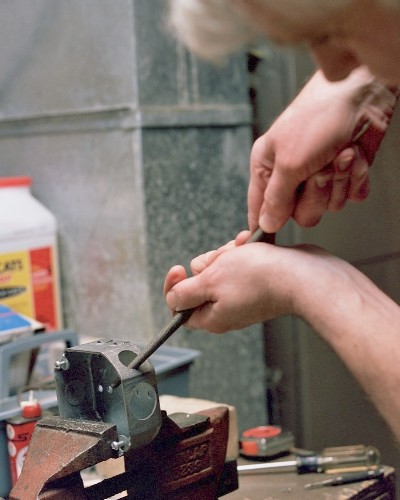 Enlarging the intake port to its final size with the full-round file (c) 2004 Larry Cottrill